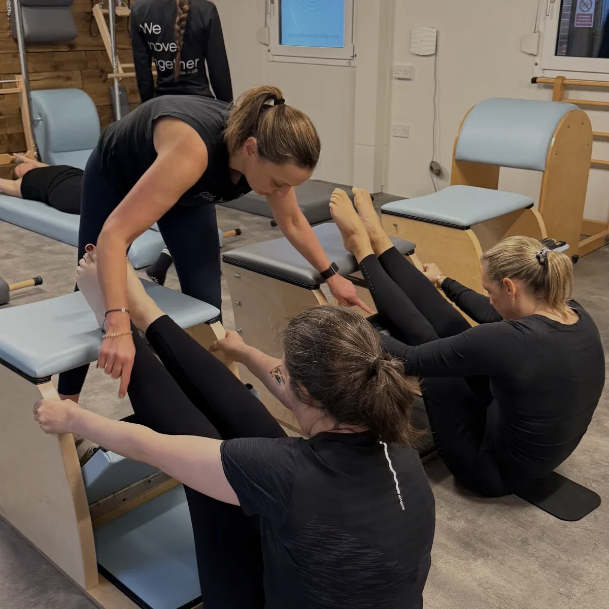A classical Pilates teacher guiding a session at Pilates From Within