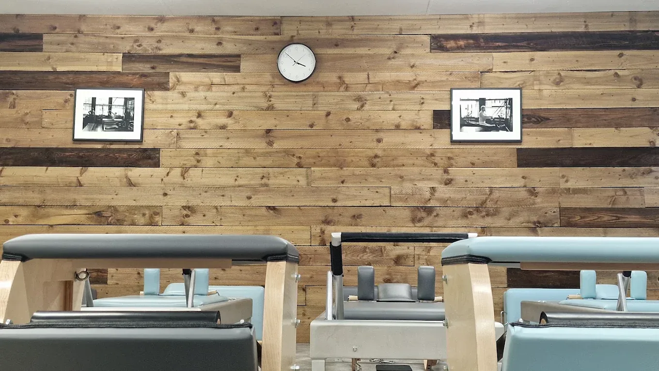 The studio wall and reformers at Pilates From Within
